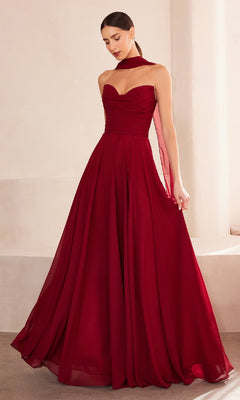 A woman wears the Strapless Long Chiffon Prom Dress: Amoris T703, a burgundy, floor-length gown with a fitted corset bodice and matching sheer scarf.