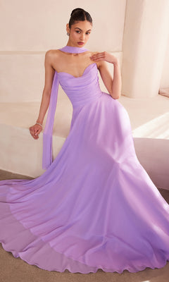 A woman in the affordable Strapless Long Chiffon Prom Dress: Amoris T703—a floor-length lavender gown with a matching scarf—sits gracefully against a light-colored wall.