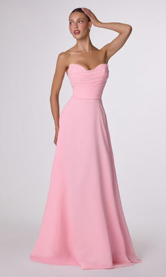 A woman poses with one hand on her head against a plain background, wearing the Strapless Long Chiffon Prom Dress: CLT703 in soft pink, featuring a corset-style bodice and an elegant A-line skirt.