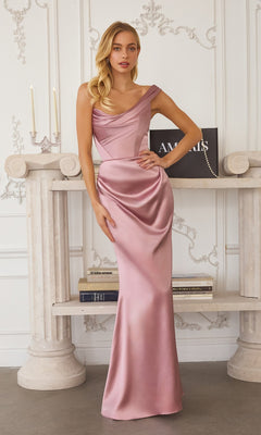 A woman in the rose Long Prom Dress: Amoris T727 stands before a decorative white wall and columns, with books and candles on a shelf behind her.