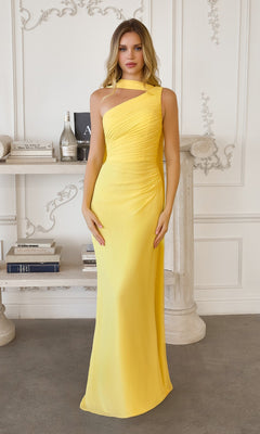 A woman poses indoors in front of a white ornate wall and shelf, wearing the Amoris T730 Long Prom Dress in light yellow, featuring a sleeveless design, ruched bodice, and flowing column skirt.