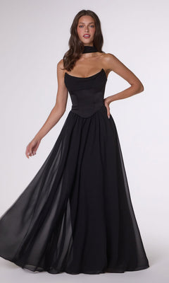 A woman poses against a plain light background wearing the Amoris T741 long black prom dress, featuring a strapless fitted satin corset bodice and a flowing A-line chiffon skirt.