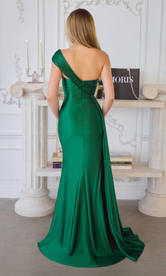 A woman in the Amoris T817 One-Shoulder Long Chiffon Prom Dress in green stands with her back to the camera in an elegant room decorated with candles, books, and ornate wall details.