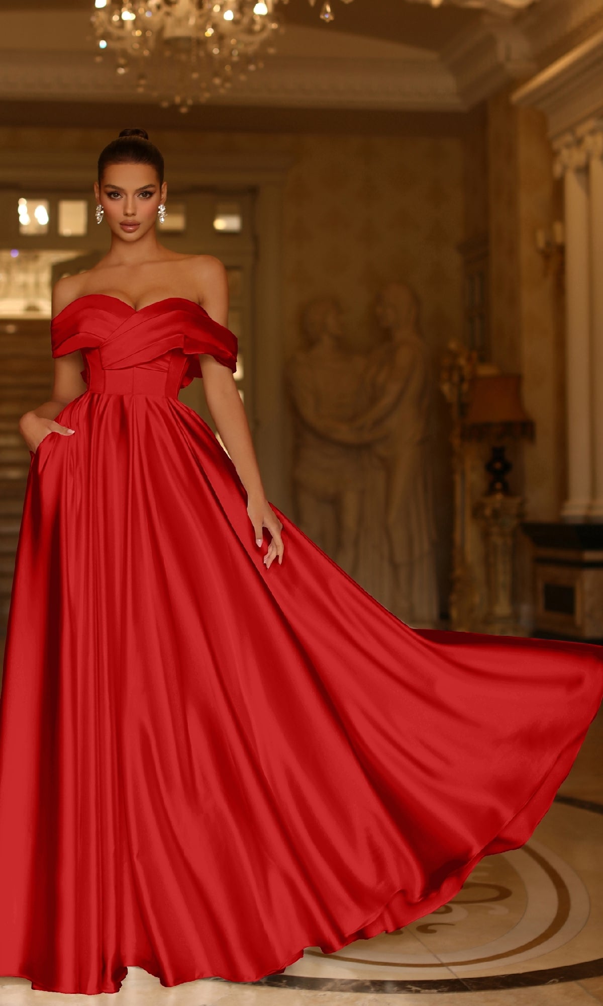 A woman in the Bow-Back Long Prom Ball Gown, Tina Holly TE207, stands gracefully in an elegant room adorned with statues and chandeliers.