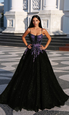 A woman stands outdoors in front of a white, columned building wearing the Tina Holly TE216B Long Formal Dress, a black gown featuring purple floral embroidery and a high-leg slit.