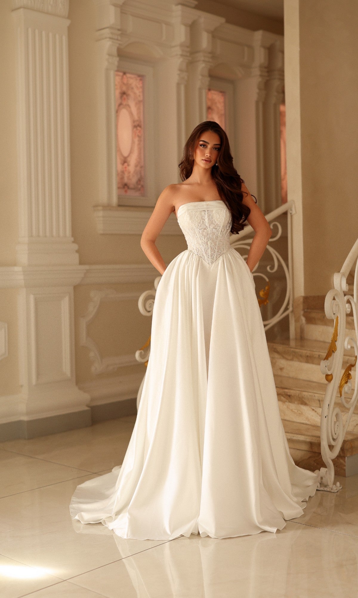 A woman in an off-white Long Wedding Dress: Tina Holly TE711, a strapless A-line gown with a textured bodice and a full, floor-length skirt.