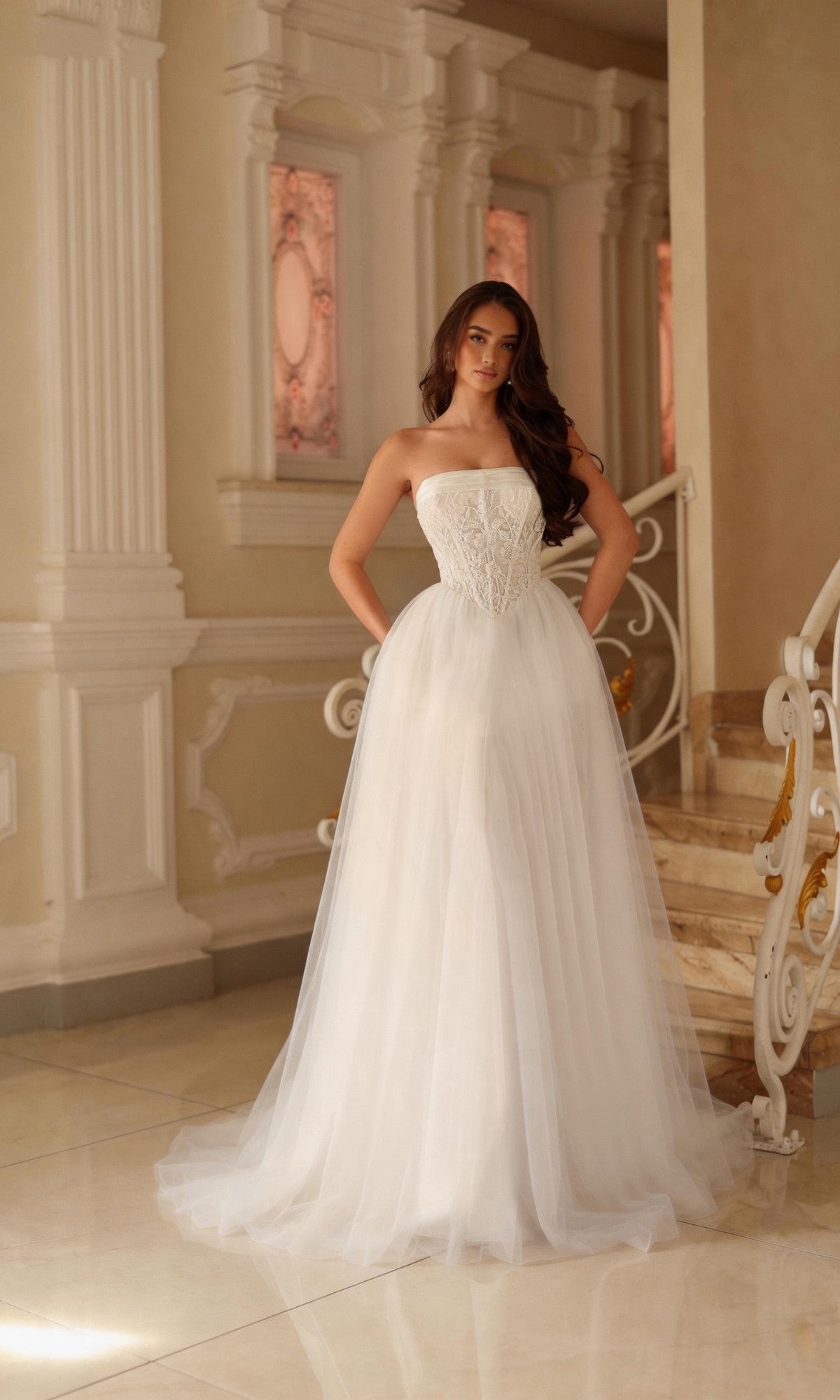 Off-white strapless Tina Holly TE713 wedding dress with a fitted, beaded lace bodice and a full tulle A-line skirt.