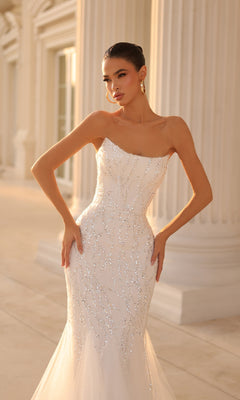 Woman wearing the Strapless Long Glitter Prom Gown: Tina Holly TK807, posing outdoors in front of tall columns.