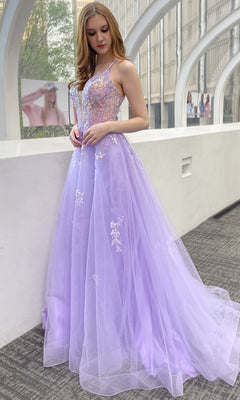 A woman wearing the Floral-Embellished Pastel Prom Ball Gown TM1003 stands indoors by a curved window, with city buildings visible outside.