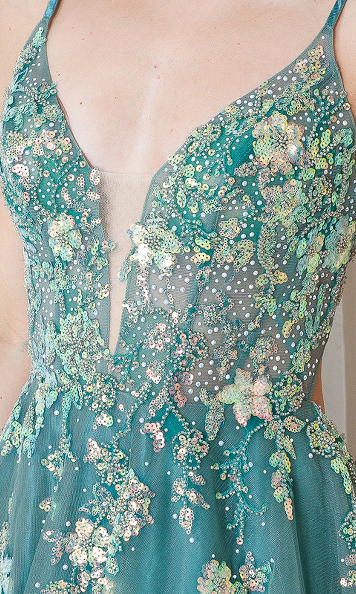Close-up of the Floral-Embellished Pastel Prom Ball Gown TM1003, showcasing intricate floral embroidery, sequins, and beads with a sheer deep V-neckline and delicate floral adornments.