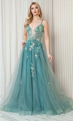 A woman in the Floral-Embellished Pastel Prom Ball Gown TM1003 stands against a light-colored, textured wall.