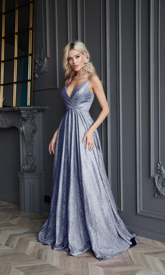A woman stands indoors wearing the Tina Holly TW079 Long Glitter A-Line Prom Dress, featuring a shimmering deep v-neck and full skirt, as she poses against an ornate gray-paneled wall.