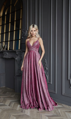 A woman in the Tina Holly TW079 Long Glitter A-Line Prom Dress stands indoors against a decorative gray wall and ornate fireplace, radiating elegance.