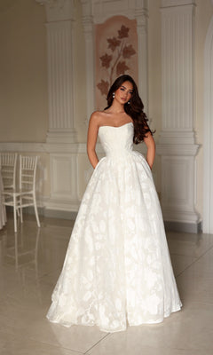 Off-white Tina Holly TW627 strapless A-line ballgown featuring a full, textured floral skirt made of organza jacquard.