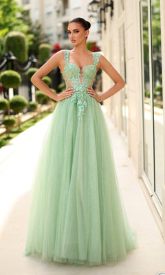 A woman stands outside in the Tina Holly TW500 long prom dress, featuring a light green, floor-length skirt, a fitted corset bodice, floral lace embroidery, and an elegant sleeveless design.