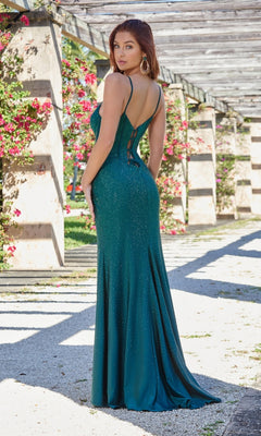A woman in the Velvi Lace-Up Long Beaded Corset Prom Dress Tia with thin straps and sparkly teal beads stands outdoors under a flowering pergola, facing away from the camera.