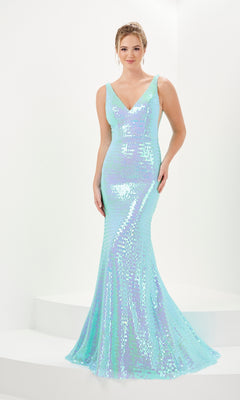 A woman wears the Micro-Fringe Long Prom Dress: Tiffany 16065, a fitted, sleeveless aqua evening gown with an iridescent finish and v-neckline, standing against a white background.