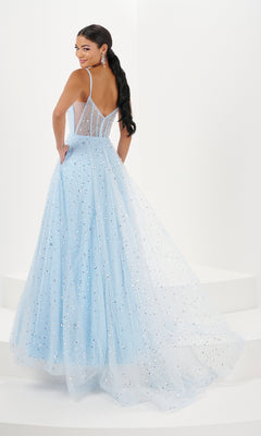 A woman in the Long Prom Dress 16066 by Tiffany—light blue, floor-length glitter tulle with thin straps, a sheer bodice, and v-neckline—stands on white steps, gazing over her shoulder.