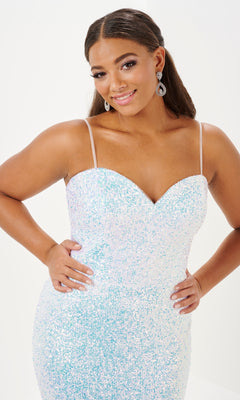A woman poses with hands on hips in the Tiffany Plus-Size Designer Sequin Prom Dress 16121, featuring a fitted silhouette, thin straps, and a sparkly light blue and white design against a plain background.