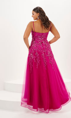 A woman stands on a white background wearing the Tiffany Long Plus-Size Floral Tulle Prom Dress 16127 in bright pink, featuring thin straps and intricate beaded embroidery on the bodice and skirt.