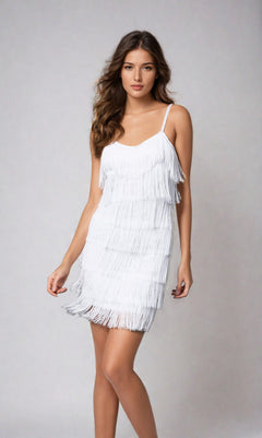 A woman models the Cheryl Creations 1415 Short Fringe Party Dress, standing against a plain light grey background facing forward with one hand slightly raised.