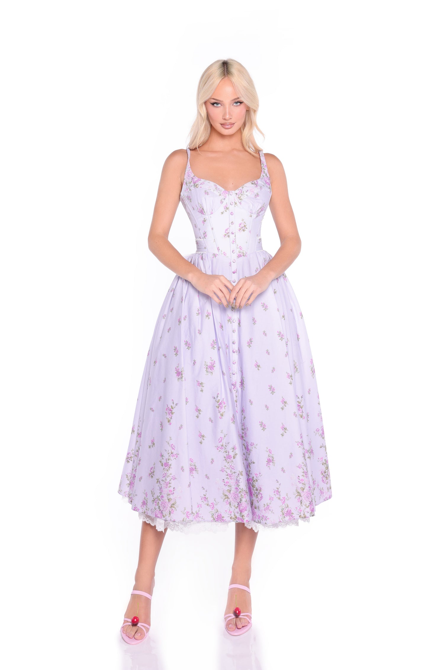 A woman stands against a white background wearing the Lilac Purple Midi Casual Dress with Bow: Violetta and pink open-toe heels.