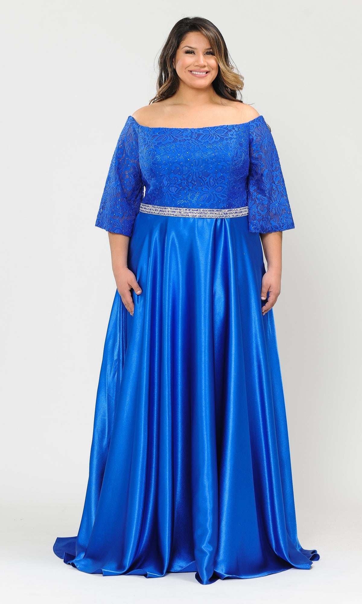 A woman in a royal blue Bell-Sleeve Plus-Size Long Prom Dress W1008 with lace sleeves and a decorative belt stands against a white background.