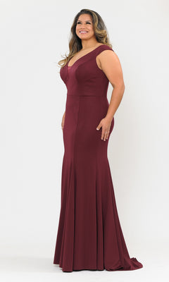 A woman in the Classic Sleeveless Plus-Size Long Prom Dress W1022, a floor-length gown with a V-neck, stands smiling and facing slightly to the side against a plain white background.