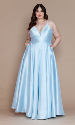 A woman models the Plus-Size Long Corset Prom Dress with Pockets W1070 in blue, featuring thin straps and a deep V-neckline, against a plain beige backdrop.