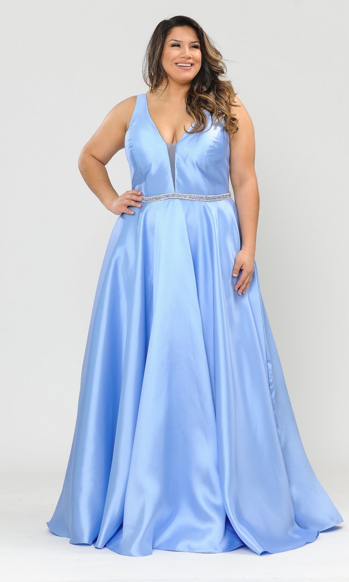 A woman in a sleeveless periwinkle V-Neck Plus-Size Long Prom Dress with pockets (style W1108) and decorative waistband stands against a plain background.