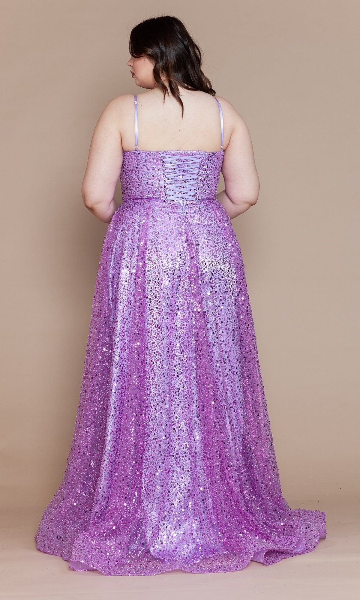 A woman, seen from behind, wears the Corset-Back Plus-Size Long Sequin Prom Dress W1142—a sleeveless floor-length lavender gown with a lace-up back—posed against a plain beige background.