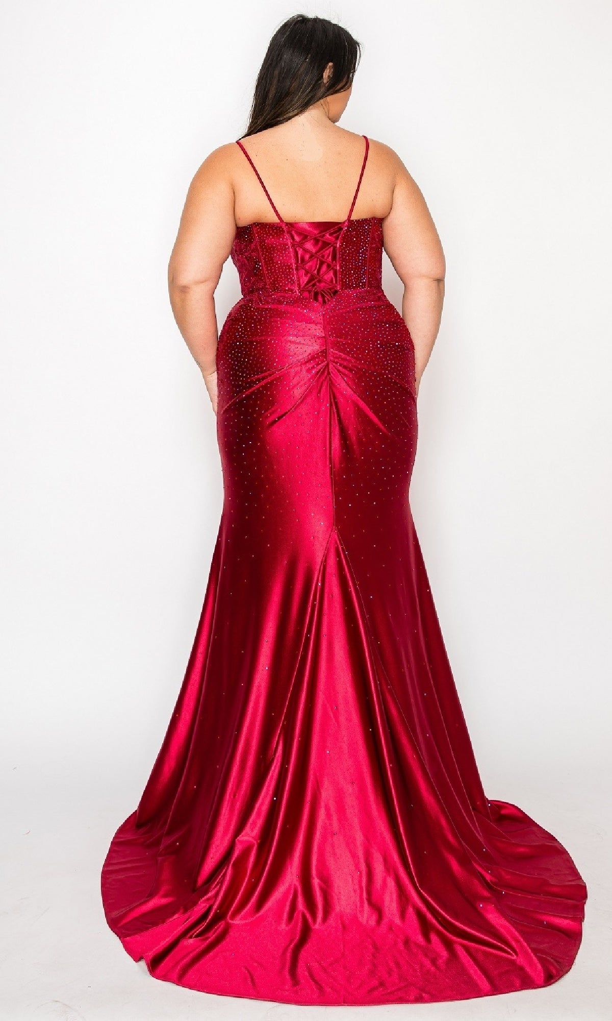 A woman in the Plus-Size Tight Beaded Prom Dress: PolyUSA W1164, a floor-length, form-fitting red gown with thin straps and a lace-up back, is seen from behind against a plain white background.