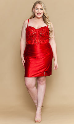 A woman models the Plus-Size Short Semi-Formal Dress: Poly USA W1178, featuring a red, sleeveless design with a beaded sweetheart bodice and fitted skirt, as she poses against a beige background.