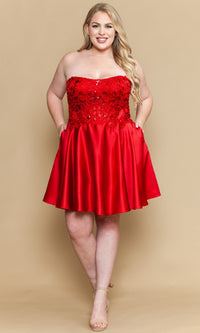 Woman wearing a red strapless dress with sequined bodice on a beige background
