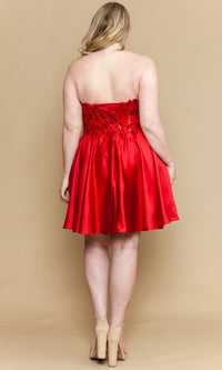 Woman wearing a red strapless dress on a beige background