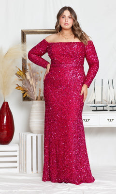 A woman wearing the Long Sleeve Plus-Size Long Sequin Prom Dress W8876 in Red Berry stands indoors near decorative plants and a white console table.