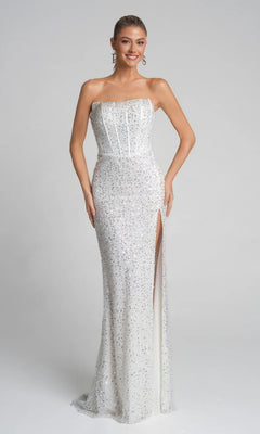A woman wears the Portia and Scarlett XO054 long formal dress in ivory—strapless, floor-length, covered in sequins, with a thigh-high slit and corset bodice—standing against a plain light background.