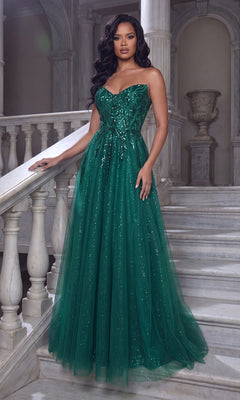 An elegant woman stands on a marble staircase in a classical interior, wearing the Portia and Scarlett XO134 long formal dress in emerald featuring a strapless design, sweetheart neckline, and sparkling embellishments.