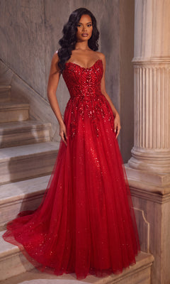 A woman in a red Portia and Scarlett XO134 long formal dress with sparkling embellishments and a sweetheart neckline stands on marble stairs beside a column.