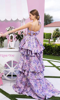 A woman in a lilac Portia and Scarlett XO181 long formal dress stands outdoors next to a white cart adorned with pink roses and a sign that reads "I Love You.