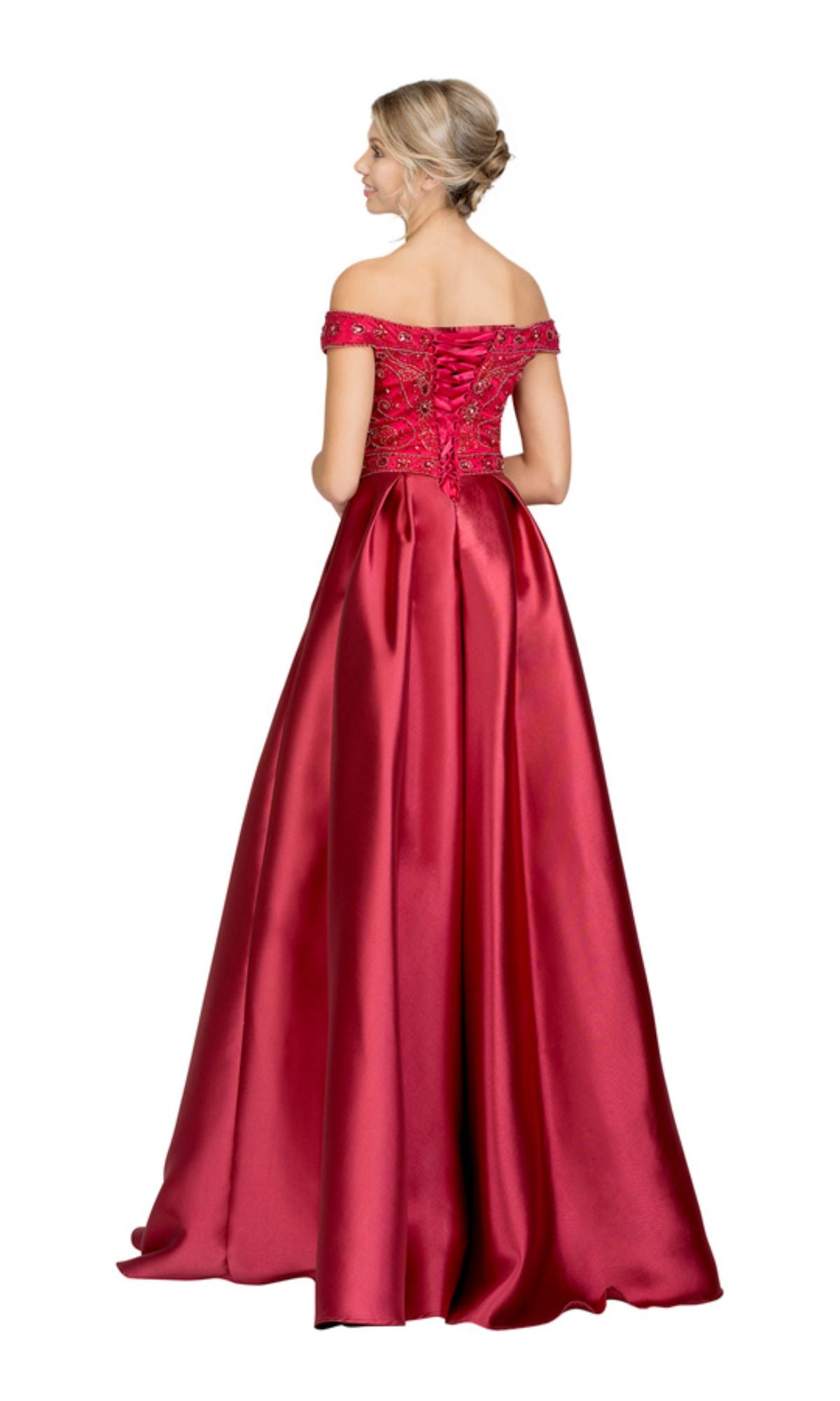 A woman stands facing away from the camera, wearing the Off-the-Shoulder Long Prom Dress: Chicas XR6007 with a lace-up back and jeweled bodice.