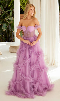 Woman in the Sheer-Waist Off-Shoulder Long Prom Ball Gown Y1472, featuring tulle and ruffle details, stands indoors by white curtains and greenery.