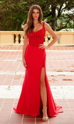 A woman stands on a tiled patio in the Nox Anabel Y1550 Lace-Corset Long Prom Dress, featuring a lace corset bodice and thigh-high slit, paired with beige high-heeled sandals. Trees and a stone railing are behind her.