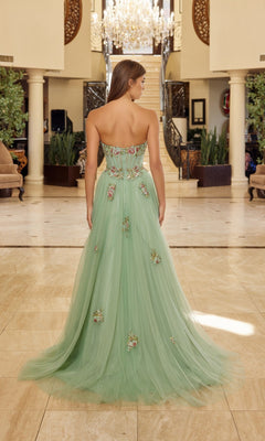 A woman wearing the Long Prom Dress: Nox Anabel Y1803 stands indoors, facing away, in a spacious, elegant hall decorated with columns and a chandelier.