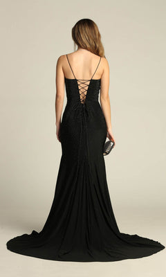 Woman in the Chicas YG5026 Lace-Up Long Beaded Prom Dress, black and backless with lace-up detail, holds a small clutch and stands facing away from the camera.