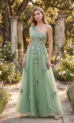 A woman stands outdoors in a garden, wearing the Long Prom Dress: Chicas YG5028—a light green gown adorned with floral embellishments, featuring an elegant A-line glitter tulle skirt and a sheer bodice that flows gracefully. Stone columns and blooming flowers create a dreamy backdrop.