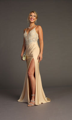 A woman in the Chicas YG5033 Lace-Bodice Slinky Long Prom Dress with a sleeveless lace bodice and side slit poses against a plain background, accessorized with strappy heels, a clutch, necklace, and earrings.