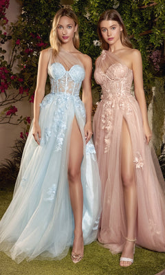 Two women stand outdoors in One-Shoulder Sheer-Bodice Long Prom Gown A1053, featuring tulle skirts with floral lace appliques and high slits—one dress in pale blue, the other in blush pink.