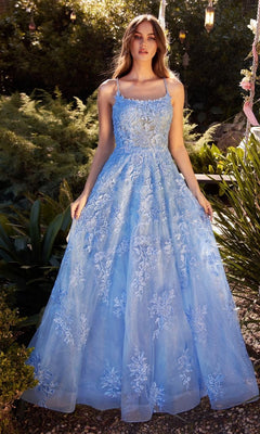A woman stands outdoors in the Andrea & Leo A1248, an Embroidered Prom Ball Gown featuring a light blue sleeveless design, floral embroidery, and a full skirt.