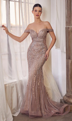 A woman stands by a window in the Andrea & Leo A1257 mauve pink long prom dress, featuring off-the-shoulder design and intricate beadwork for an elegant, stunning look.